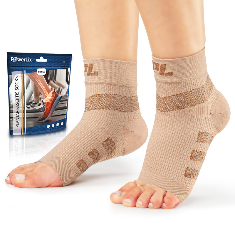 Powerlix plantar fasciitis support socks in beige on a model with the bag they come in behind the model.