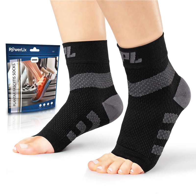 Powerlix plantar fasciitis support socks in black on a model with the bag they come in behind the model.