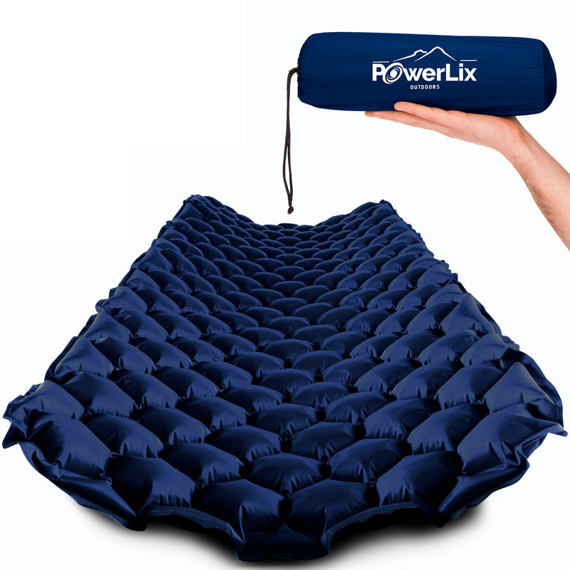 Navy inflated sleeping pad, also show stored in the Powerlix Outdoors bag, held by a hand.